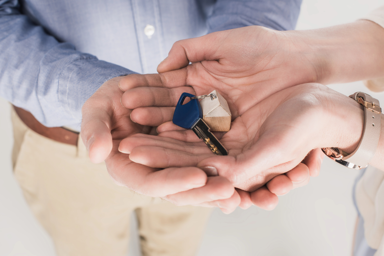 Partial view of couple holding key from new home together